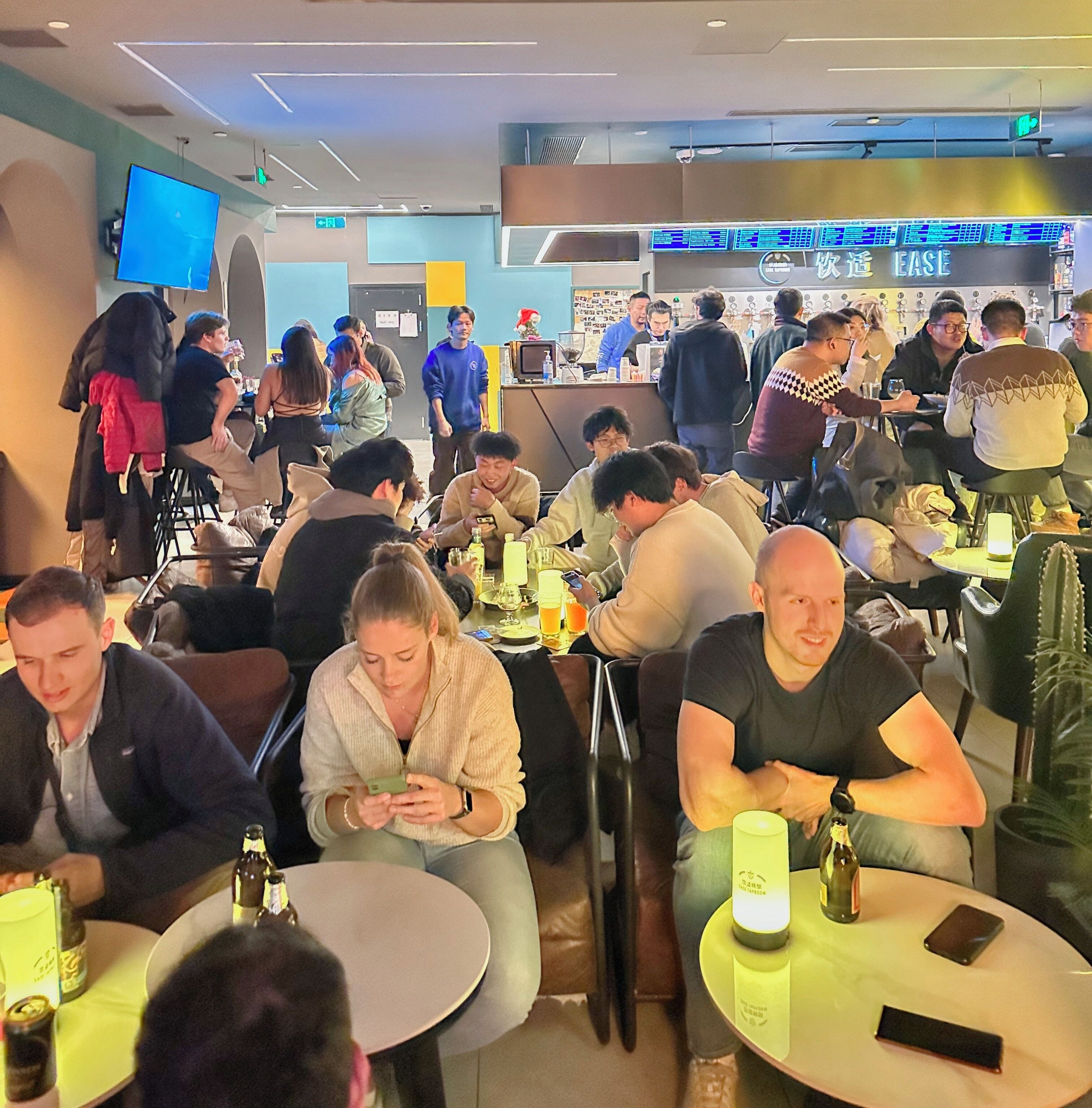 A busy restaurant with multiple tables and patrons.