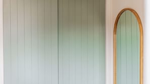 Features a large, vertical panel wall and a minimalist aesthetic with a focus on clean lines.
