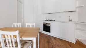 A compact kitchen with white cabinetry, a built-in oven, and a gas stove. - La Dolce Vita - Stylish Flat inTrastevere 60sqm (Roma)