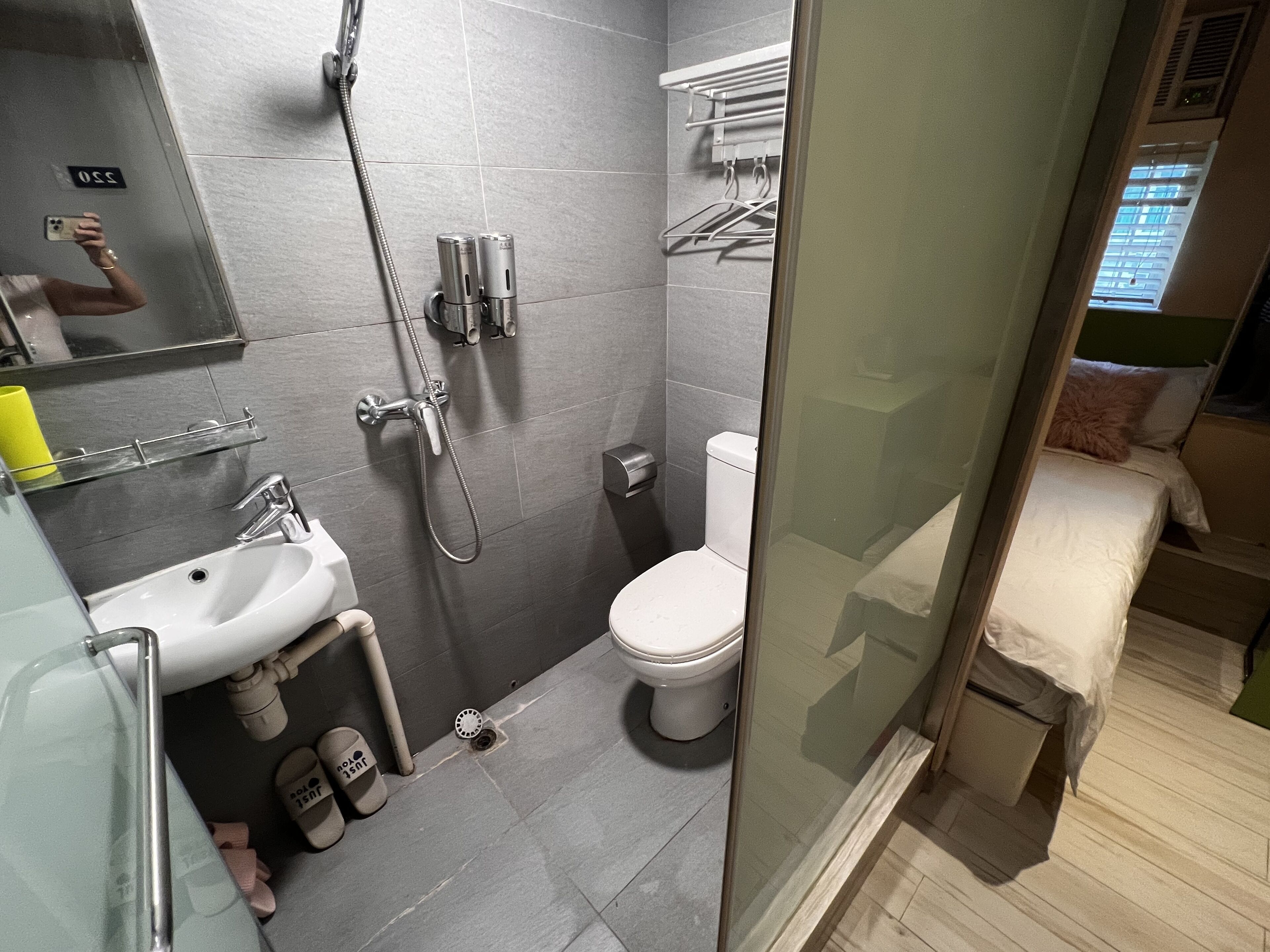 A modern bathroom with a shower, toilet, and sink.