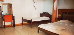 A hotel room with two wooden beds, a desk with a chair, a mirror, and a curtain. - Maralink Hotel (Narok)