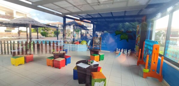 A children's play area with colorful stools, a table, and a bowling alley setup. - Tortuga Beach Lovely 2 bed Apartment and Gardens (Sal)