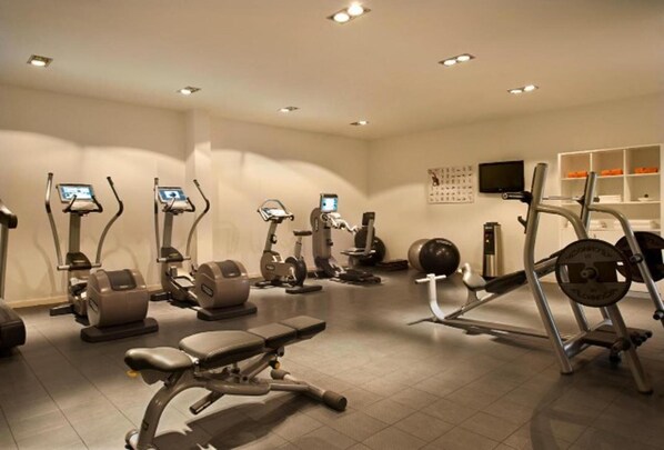 A fitness center with various exercise machines, including treadmills, elliptical trainers, and weight machines. - Tortuga Beach Lovely 2 bed Apartment and Gardens (Sal)