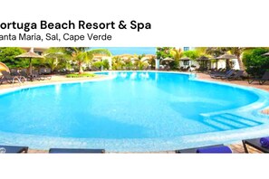 A swimming pool at a resort with lounge chairs and umbrellas.