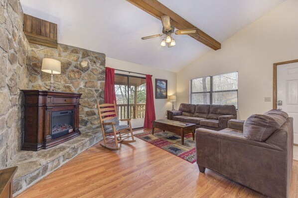 Cabaña, varias camas, chimenea, vista al jardín | Área de sala de estar | Televisión y chimenea 