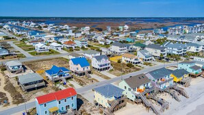 A coastal residential area with houses featuring balconies and waterfront views.