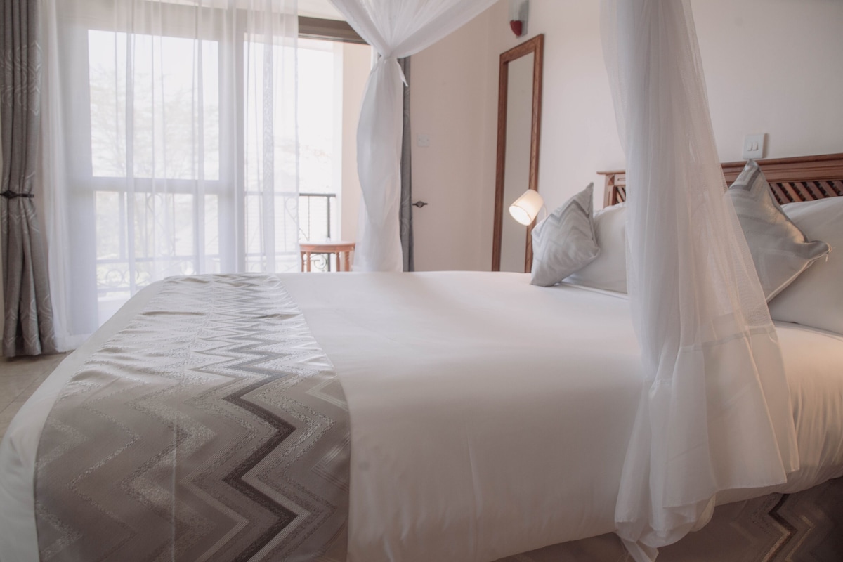 Premium bedding, desk, laptop workspace, blackout drapes