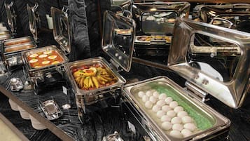 A buffet with various food items in metal containers.
