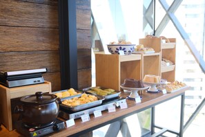 A buffet with various food items and a slow cooker.