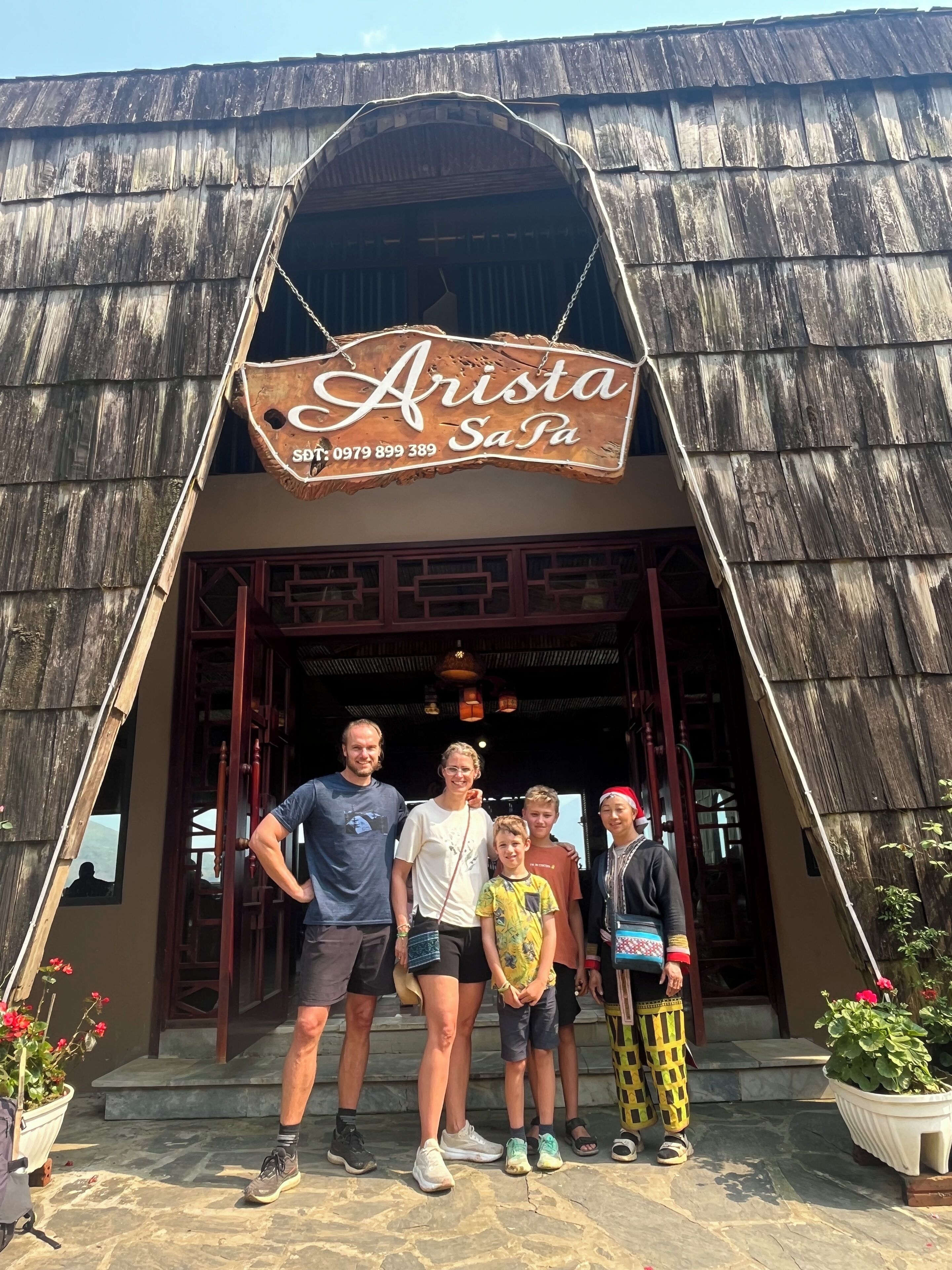 A rustic building with a sign reading "Arista Sa Pa" and a contact number.