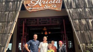 A rustic building with a sign reading "Arista Sa Pa" and a contact number.