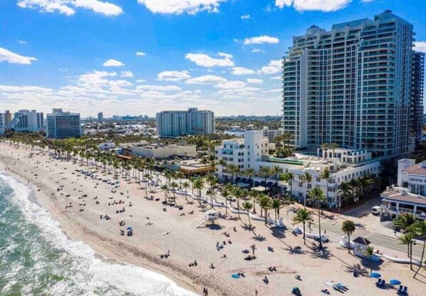Enjoy the scenic views of the beach and palm trees along the urban coastline.