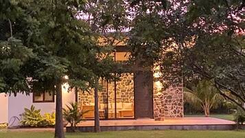 Garden-side villa exterior at dusk