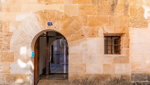 A stone building entrance with a door, a window, and a sign indicating room number 10.