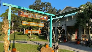 A sign for Nature Coast Inn & Cottages with a phone number.