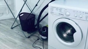 A laundry area with a washing machine, a drying rack, and a basket. - renovated studio 30m2 5 min from the train station (Bordeaux)