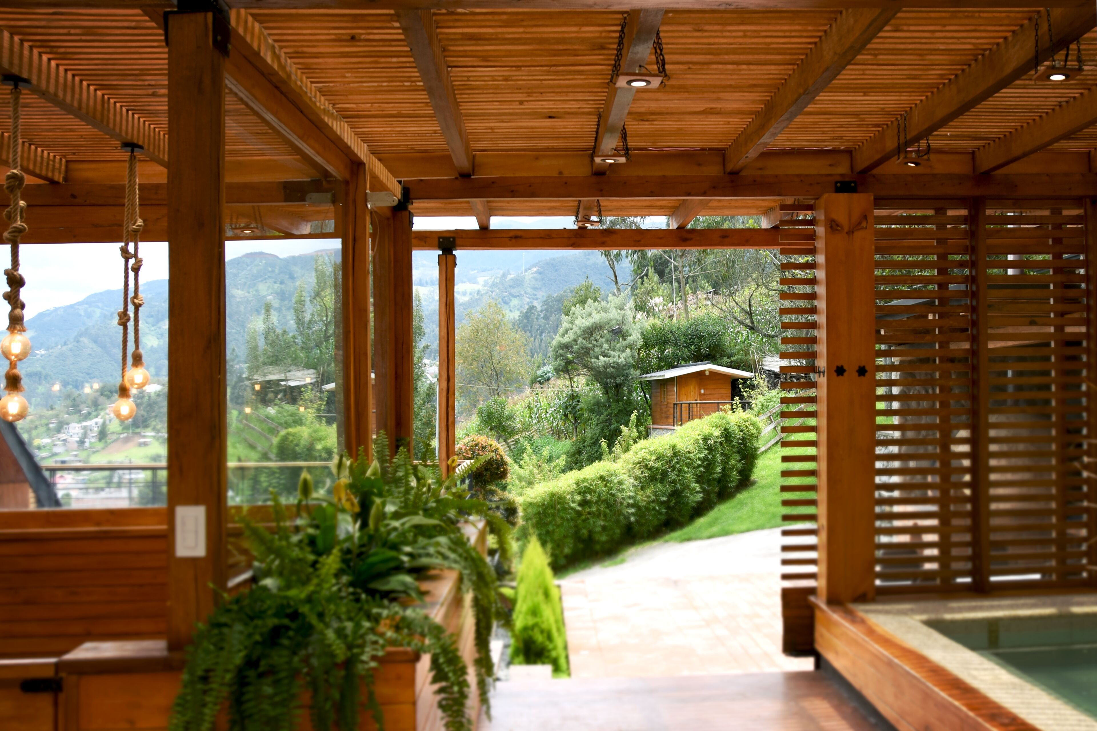 A wooden interior with a view of a mountainous landscape.