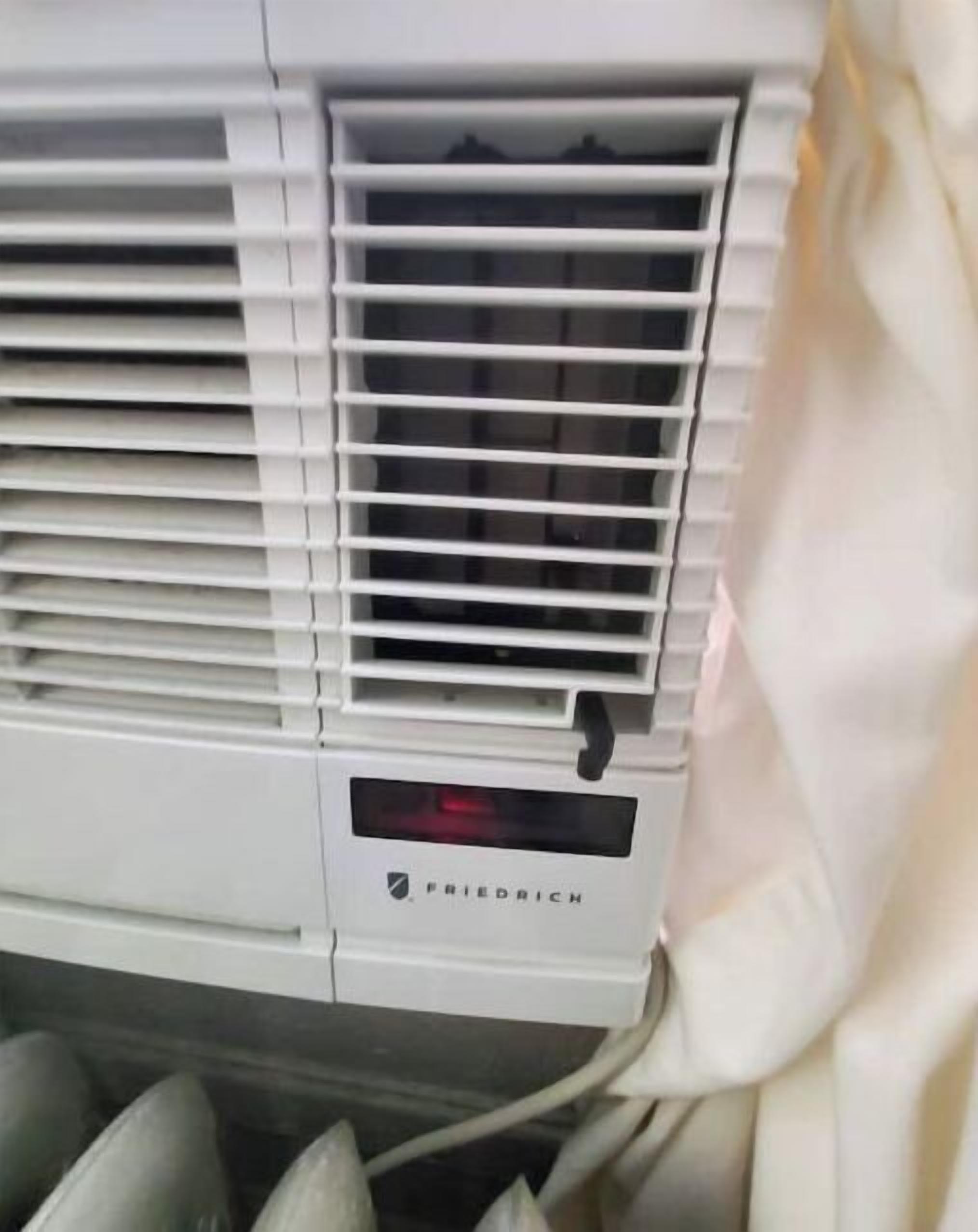 A white air conditioning unit with the brand name 'Friedrich' visible.