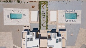 An aerial view of a hotel with two swimming pools, a central courtyard, and multiple rooms. - Rocks Naxian Villa With Private Pool (Naxos)