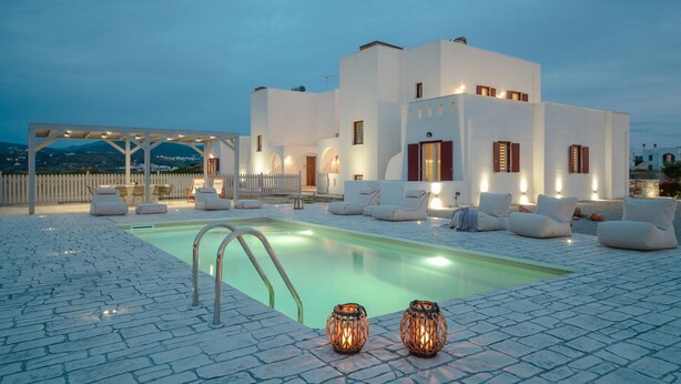 A modern building with a swimming pool, outdoor seating, and a pergola. - Rocks Naxian Villa With Private Pool (Naxos)