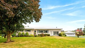 A single-story house with a front lawn, a driveway, and a garage.