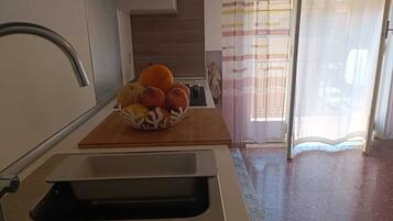 Full-sized fridge, oven, cookware/dishes/utensils, spices