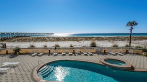A pool area with a view of the beach and a pier. - 🌞🌞Gulf Views | Pool | Walk to Pier | 3BR Summerwind Center 704🌞🌞 (Navarre)