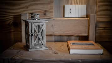 A rustic wooden table with a metal lantern and a book.