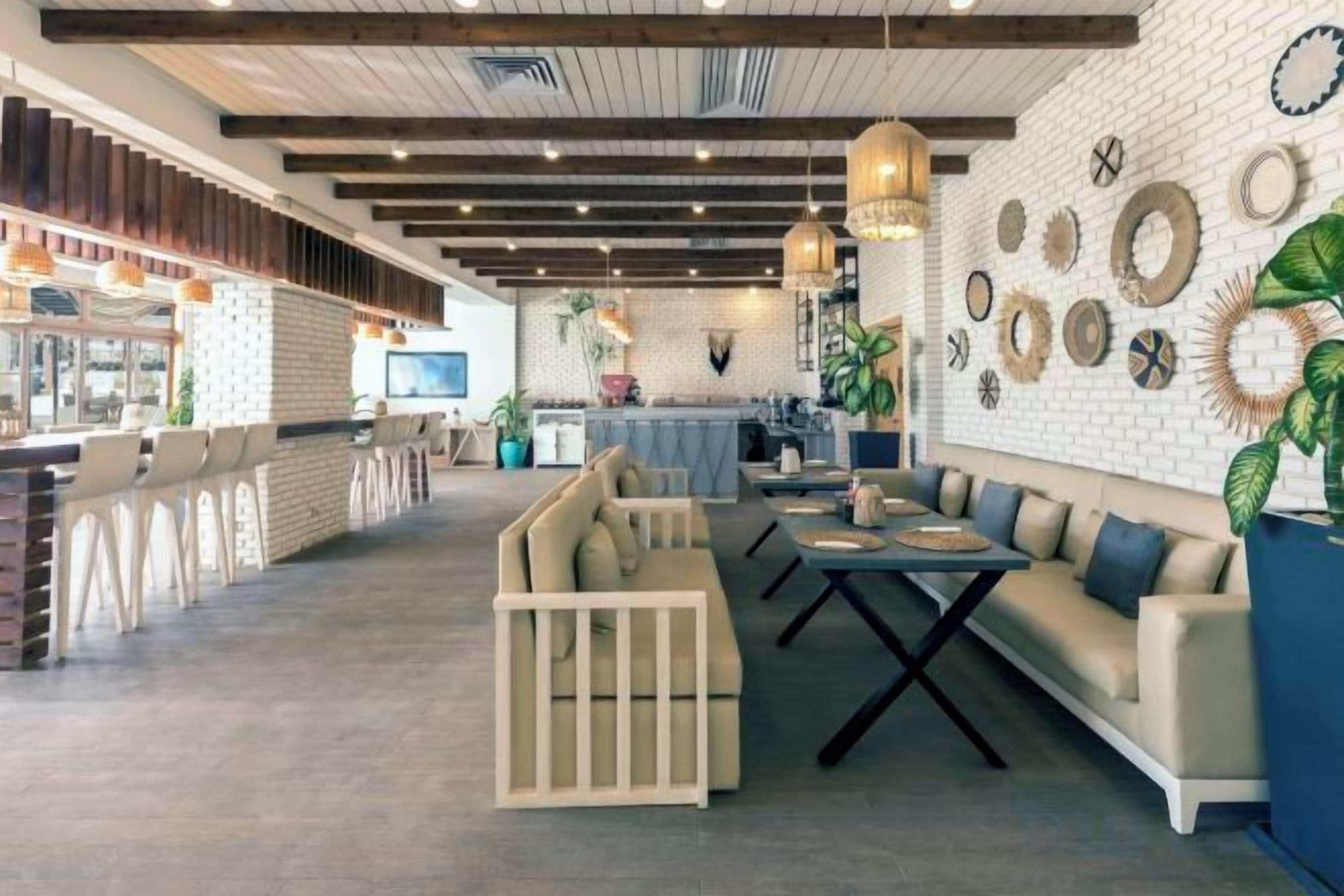 A modern interior with a bar area, seating arrangements, and decorative wall elements.