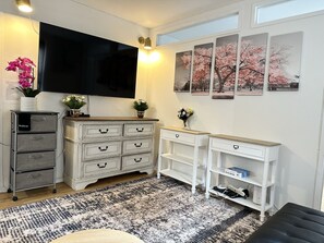 Enjoy a well-organized living space with a flat-screen TV, ample storage, and a stylish console table.