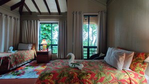A room with two beds, a large window, and a swan decoration on the bed. - Luxury, affordable, close to town and all of the attractions in the CAYO area... (Santa Elena)