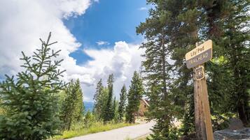 A signpost with 'Lily Pad Trailhead' and a building in the background.