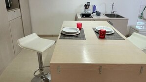 A modern kitchen with a central island, a sink, and a toaster. - Nest of the Maximum loft (Palermo)