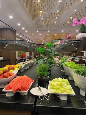 A buffet with various fruits and vegetables.