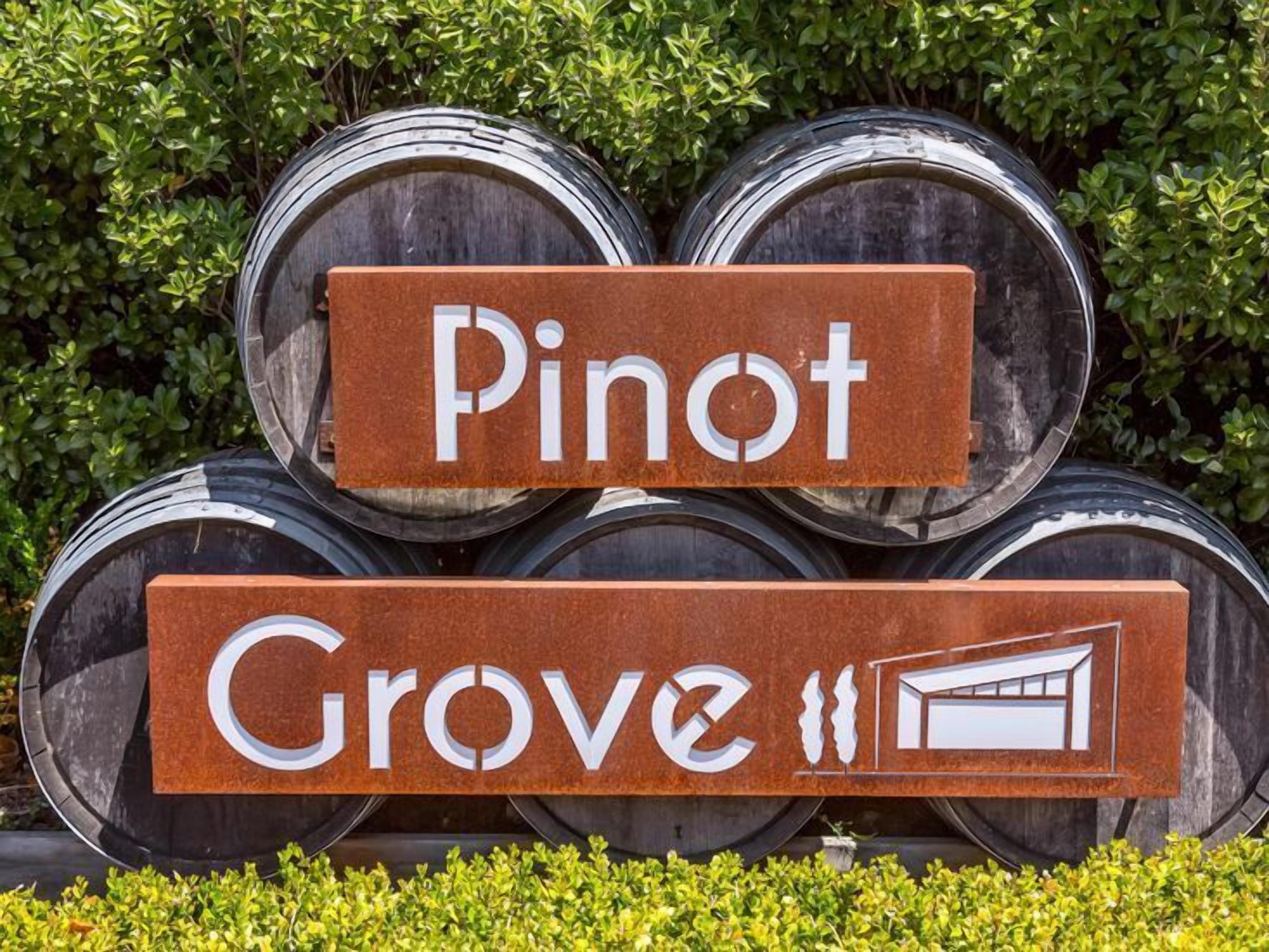 A sign with the words "Pinot" and "Grove" indicating a wine-related establishment.