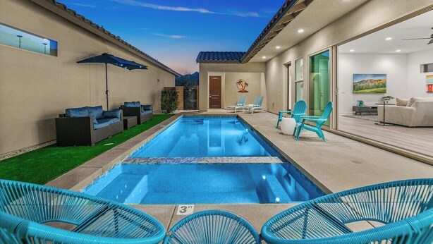 A swimming pool with lounge chairs and a patio area. - Golfer's Paradise: EV Charger, Private Pool & Putting (La Quinta)