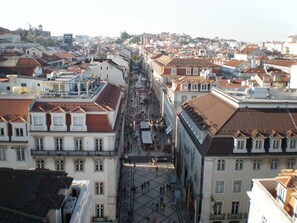 A historic cityscape with traditional architecture, a central square, and a bustling pedestrian area. - New apartment in the historic center (Lisboa)