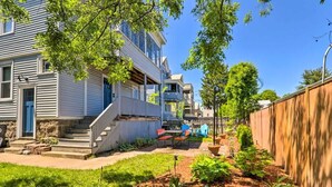 A residential area with a well-maintained garden, a wooden fence, and a two-story house with a visible balcony. - Family-Friendly Salem Apt: Near Dtwn Sites! (Salem)