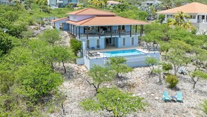 A modern two-story house with a swimming pool, surrounded by greenery and hills. - Villa blue Oasis, Coral Estate, Curacao (Willemstad, Curacao, Curacao, Caribbean)