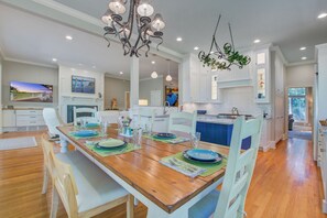 Enjoy meals in this well-appointed dining area with a large table and modern kitchen.