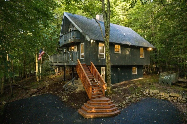 Cozy two-story retreat nestled in the woods with scenic outdoor spaces.