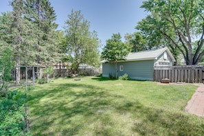Enjoy a serene retreat in this charming home with a porch and lush green surroundings.