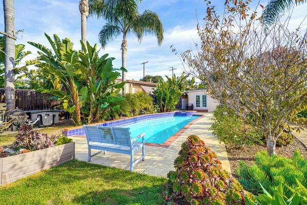 A backyard with a swimming pool, a bench, and various plants. - Santa Barbara Home w/ Private Outdoor Pool! (Santa Barbara)