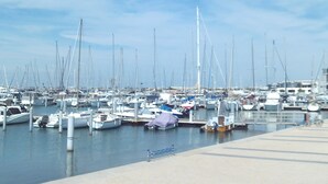A marina with numerous boats docked at the pier.