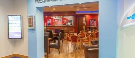 A restaurant bar with a bar area, seating, and a counter.