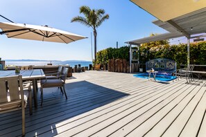 A wooden deck with outdoor furniture, a pool, and a view of the ocean. - Oceanfront-2730 sqft w/SPA, HugeDeck+Garden+VIEWS (San Pedro)