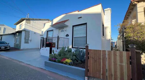 Stroll up to this charming home, featuring a cozy front porch and a beautifully tended garden.