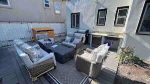 An outdoor patio area with wicker furniture, a grill, and a small garden. - House-view & 5 min Walk to Beach (Hermosa Beach)