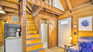 A wooden interior with a staircase, a white door, and a small table with a lamp. - Okeechobee Cabin in Waterfront Community w/ Dock! (Okeechobee)