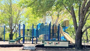 A playground with a slide and climbing structures. - Park and Walk! Downtown Rehoboth Beach Condo (Rehoboth Beach)